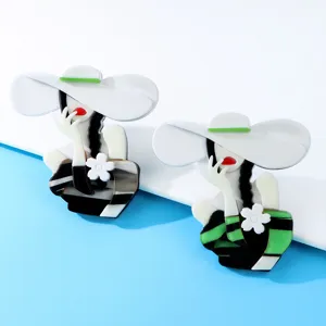 Detailed macro view of two elegant acrylic girl brooches in fashion acetate material