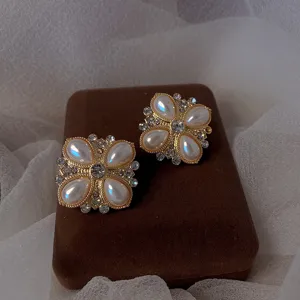 Detailed view of vintage baroque style earrings featuring teardrop pearls and crystals