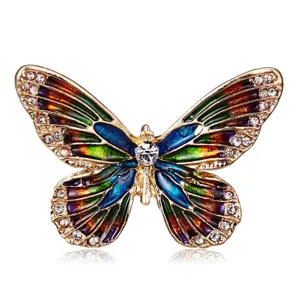 Close-up of a vintage colorful enamel butterfly brooch featuring crystal accents