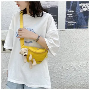 Casual yellow canvas waist bag for women featuring a cute plush bear attachment detail.