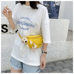 Detail of yellow canvas waist bag with cute plush teddy bear decor for women