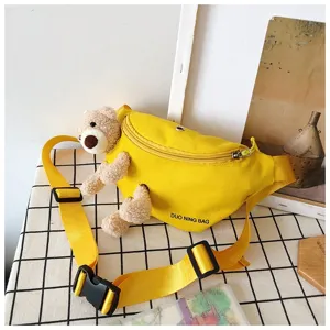Yellow canvas chest bag with cute plush teddy bear decor for casual outdoor style