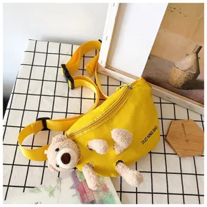 Detail of yellow canvas chest bag with creative plush bear toy design