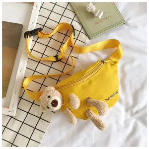 Detail view of yellow canvas waist bag featuring a cute 3D plush teddy bear design.