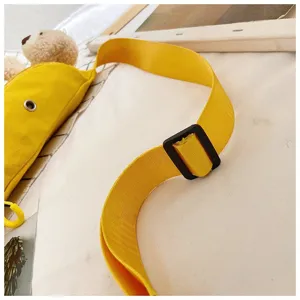 Close-up of adjustable yellow canvas strap and black buckle on a cute bear bag