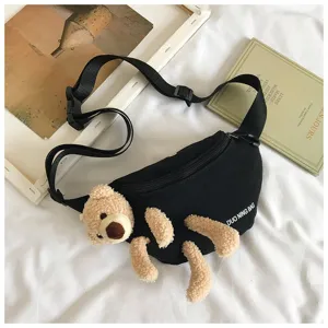 Close-up detail of casual black canvas fanny pack featuring a cute plush bear decoration
