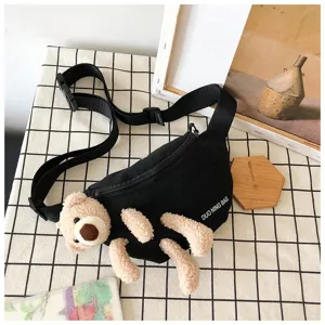 Detailed view of a cute 3D plush bear attached to a black canvas waist bag for women