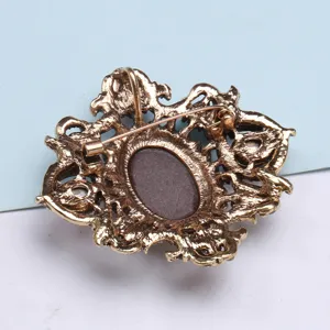 Back view detail of a vintage palace style metal brooch with a secure safety pin clasp