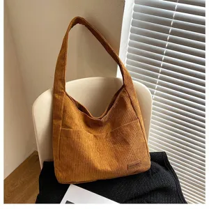 Close-up of a stylish brown corduroy tote bag highlighting the soft ribbed texture