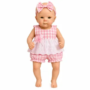Detailed view of 12-inch silicone baby doll in pink gingham romper and headband