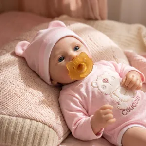 Close-up of 16-inch silicone baby doll featuring soft bear romper and pink ear hat