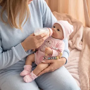 Close-up of a 16-inch lifelike soft silicone baby doll with bear print outfit and bottle