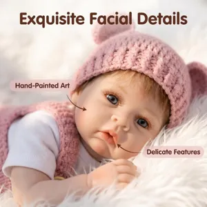 Hand-painted facial details on realistic 22-inch reborn doll with pink knitted hat
