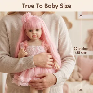 Detailed view of a 22-inch realistic reborn doll with pink long hair being held