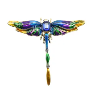 Detailed view of vintage enamel dragonfly brooch with blue crystal rhinestone accent