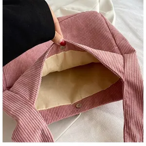 Close-up of pink corduroy tote bag interior with magnetic snap closure and beige lining