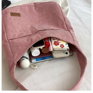 Detail view of the spacious interior of a pink corduroy tote bag for daily essentials