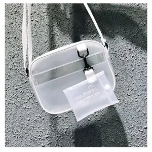 Vue détaillée du sac bandoulière semi-transparent avec sangle blanche et pochette.