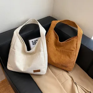 Stylish large capacity corduroy tote bags for women, available in cream and brown colors
