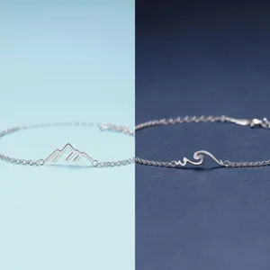Minimalist silver couple bracelets featuring mountain and wave charms for long distance lovers