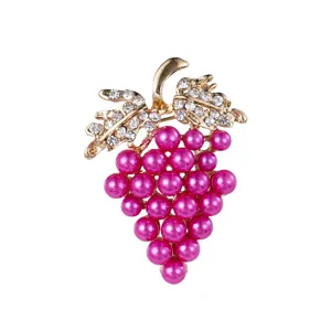 Detailed close-up showing fuchsia faux pearl grape brooch with sparkling crystal leaves