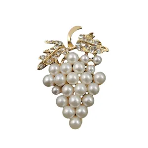 Macro detail of elegant grape brooch with white pearls and sparkling crystals