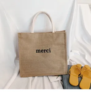 Large-capacity jute tote bag with a minimalist 'merci' print for casual daily use.