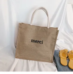 Casual jute tote bag with 'merci' print and cotton rope handles for beach trips