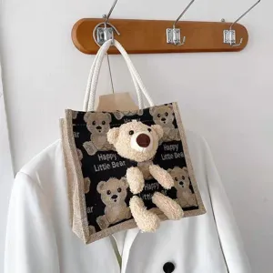 Detail view of linen tote bag with 3D plush teddy bear and printed design