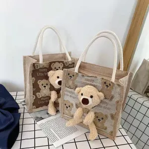 Cute jute handbag with plush teddy bear decor for women and students stylish lunch bag.