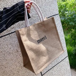 Large eco-friendly jute tote bag with merci print and durable rope handles for daily use