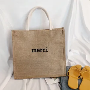 Eco-friendly large jute tote bag with 'merci' print and durable white rope handles