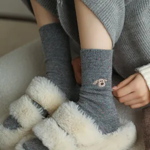 Close-up detail of grey wool blend mid-tube socks featuring cute embroidered dog pattern.
