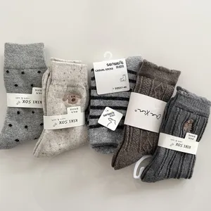Grey wool socks for women, cozy mid-tube knit collection, autumn winter wear, soft warm essentials.
