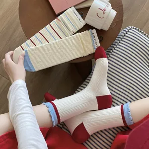 Vue détaillée de chaussettes en coton blanc pour femmes à rayures rouges et bleues.