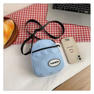 Pequeño bolso bandolera de nailon azul claro minimalista para estudiantes con móvil