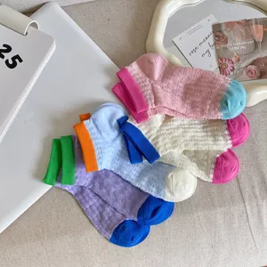 Detailed shot of candy color hollow breathable mesh ankle socks with contrasting color toes.