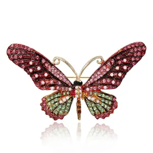 Close-up of vintage butterfly brooch with colorful rhinestones and gold finish