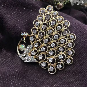 Close-up of a vintage gold peacock brooch inlaid with sparkling rhinestone crystals