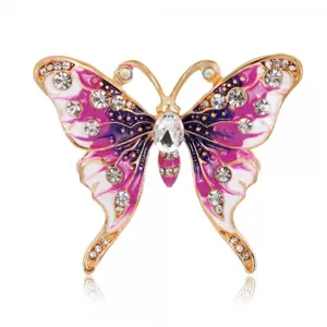 Detailed macro shot of vintage butterfly brooch with purple enamel and crystal accents.