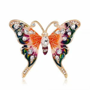 Close-up of a vintage butterfly brooch featuring colorful enamel and inlaid crystals