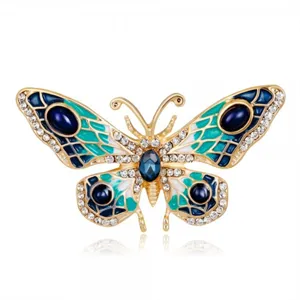 Close-up of vintage crystal butterfly brooch with blue and green enamel detail.