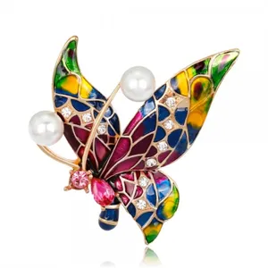 Close-up detail of vibrant colorful enamel butterfly brooch with pearls and rhinestones