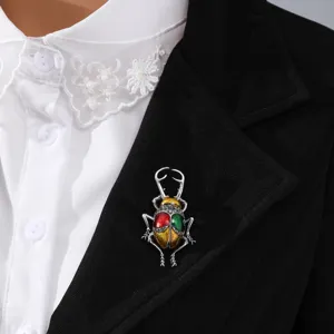 Close-up of a vintage beetle brooch with colorful enamel and crystals on a blazer lapel