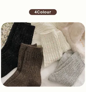Close-up of four colors of women's ribbed speckled yarn wool socks for winter warmth