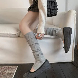 Detailed view of grey ribbed stirrup leg warmers showing knit texture and cozy style