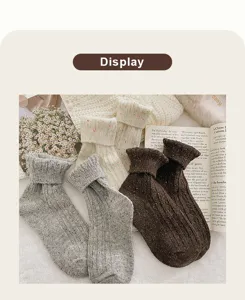 Detailed texture of thick winter wool socks with colorful flecked yarn and ribbed cuff