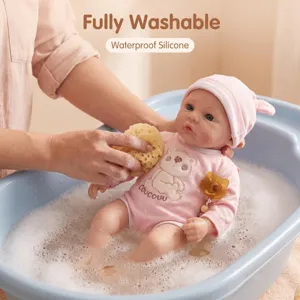 Detail view showing 16 inch silicone baby doll being washed in a blue bathtub.