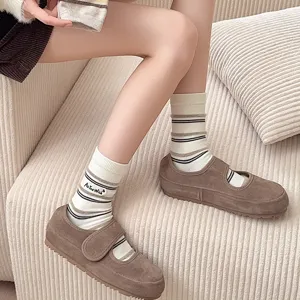Close-up of white striped mid-calf socks with 'As You Wish' embroidery