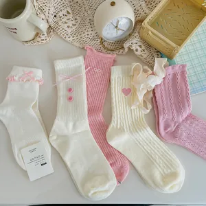 Detailed view of cute Japanese style pastel socks with bows, hearts and ruffles.